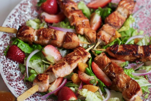 honey garlic salmon skewers on summer salad