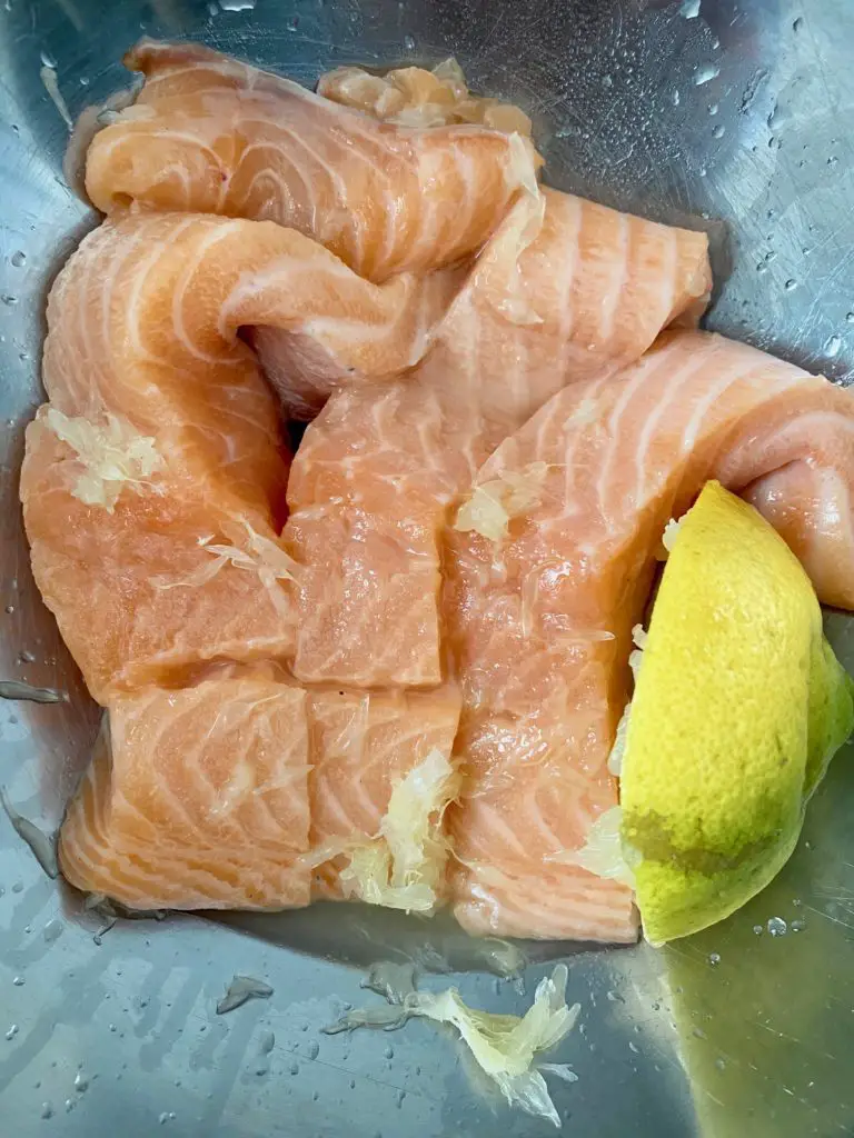 marinating the salmon in lemon juice 