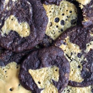 a batch of chewy chocolate cookies with homemade peanut butter chips