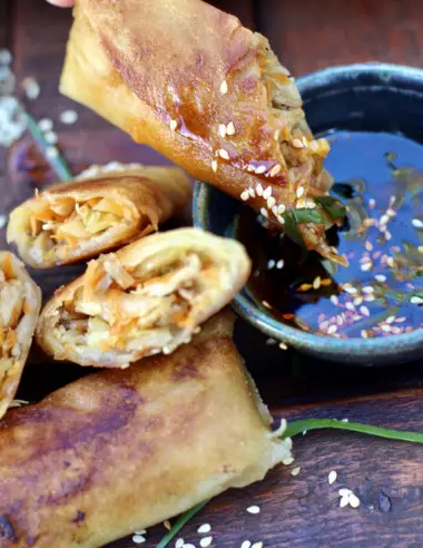 chicken spring roll dipped in ginger sesame sauce