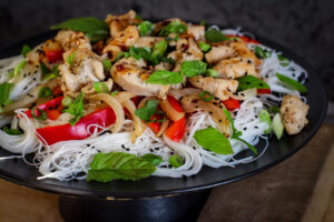 adding the mint and scallion to the salad 