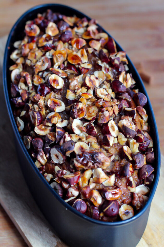 candied walnuts and hazelnuts on date cake 