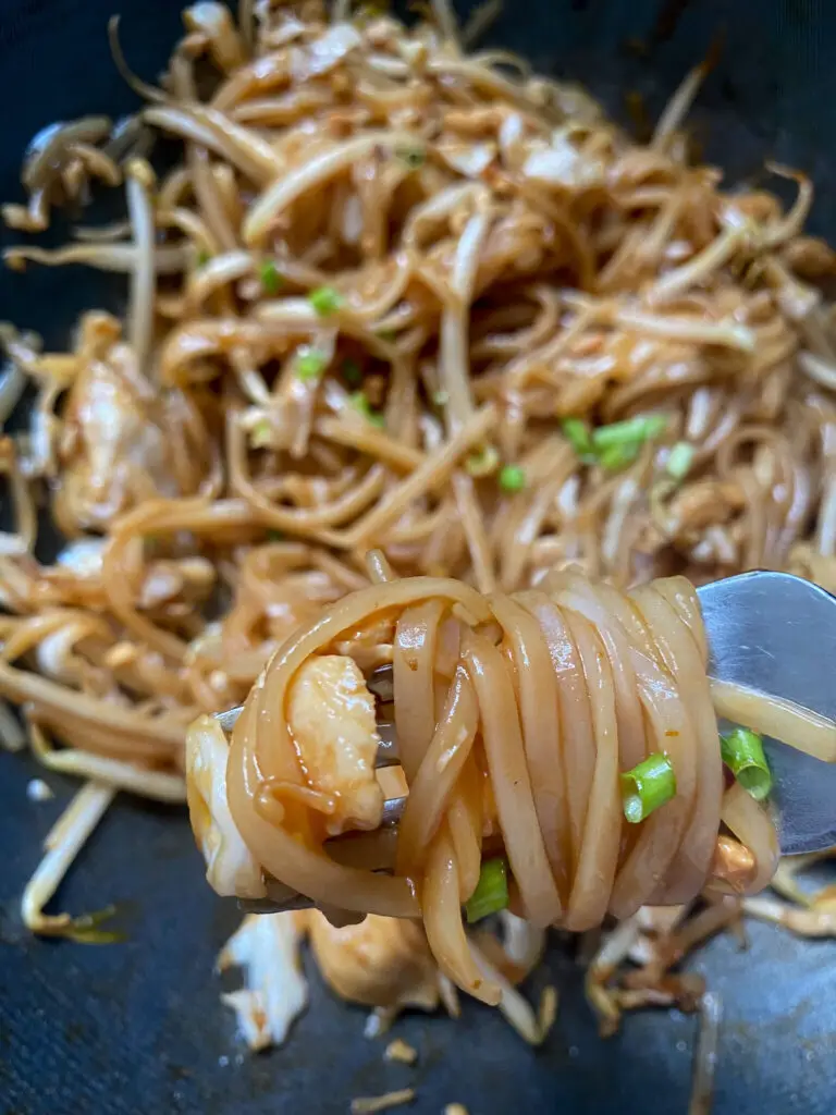 forkful of saucy pad thai 