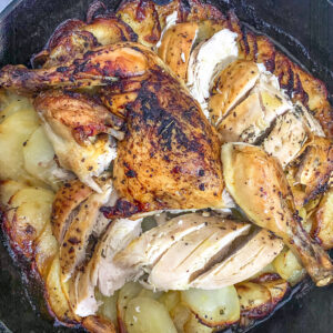 pollo asado con patatas in a skillet