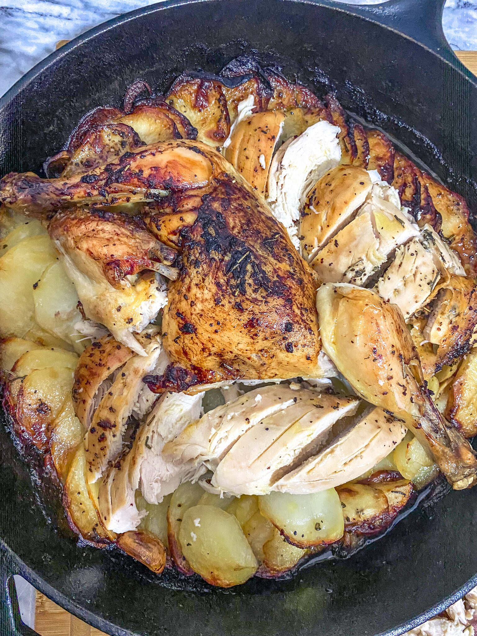 pollo asado con patatas in a skillet