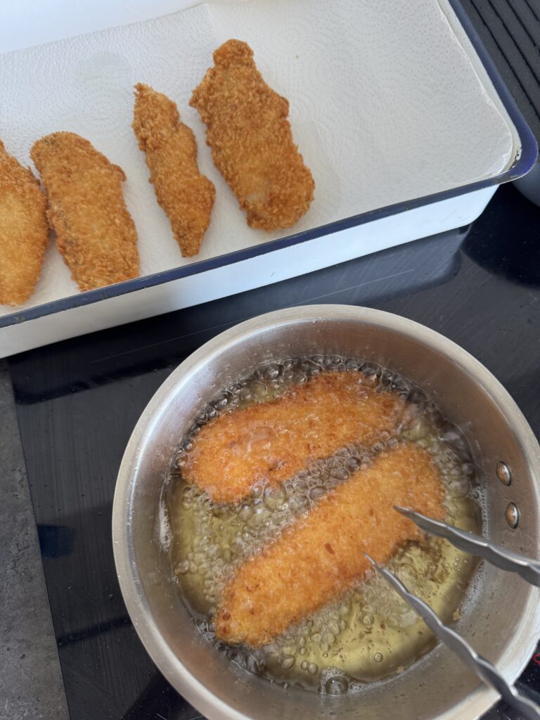 Frying jumbo fish fingers 